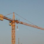 yellow crane under blue sky during daytime