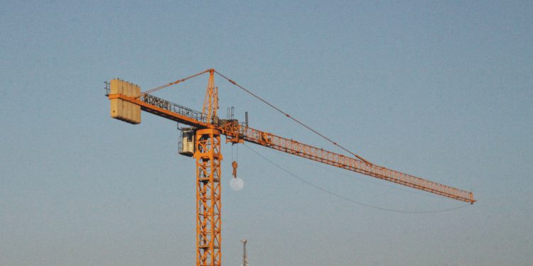 yellow crane under blue sky during daytime